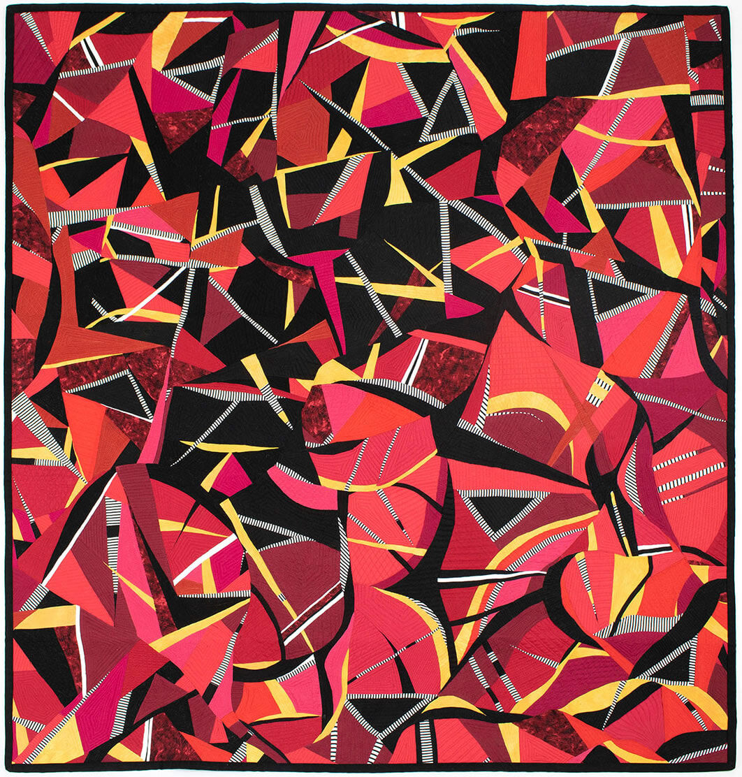 An art quilt 'Crown Of Thorns' textile made by Suzanne Lyle in 2020 design is mainly reds, black, yellow and white, an abstract design inspired by the crown of thorns plant.