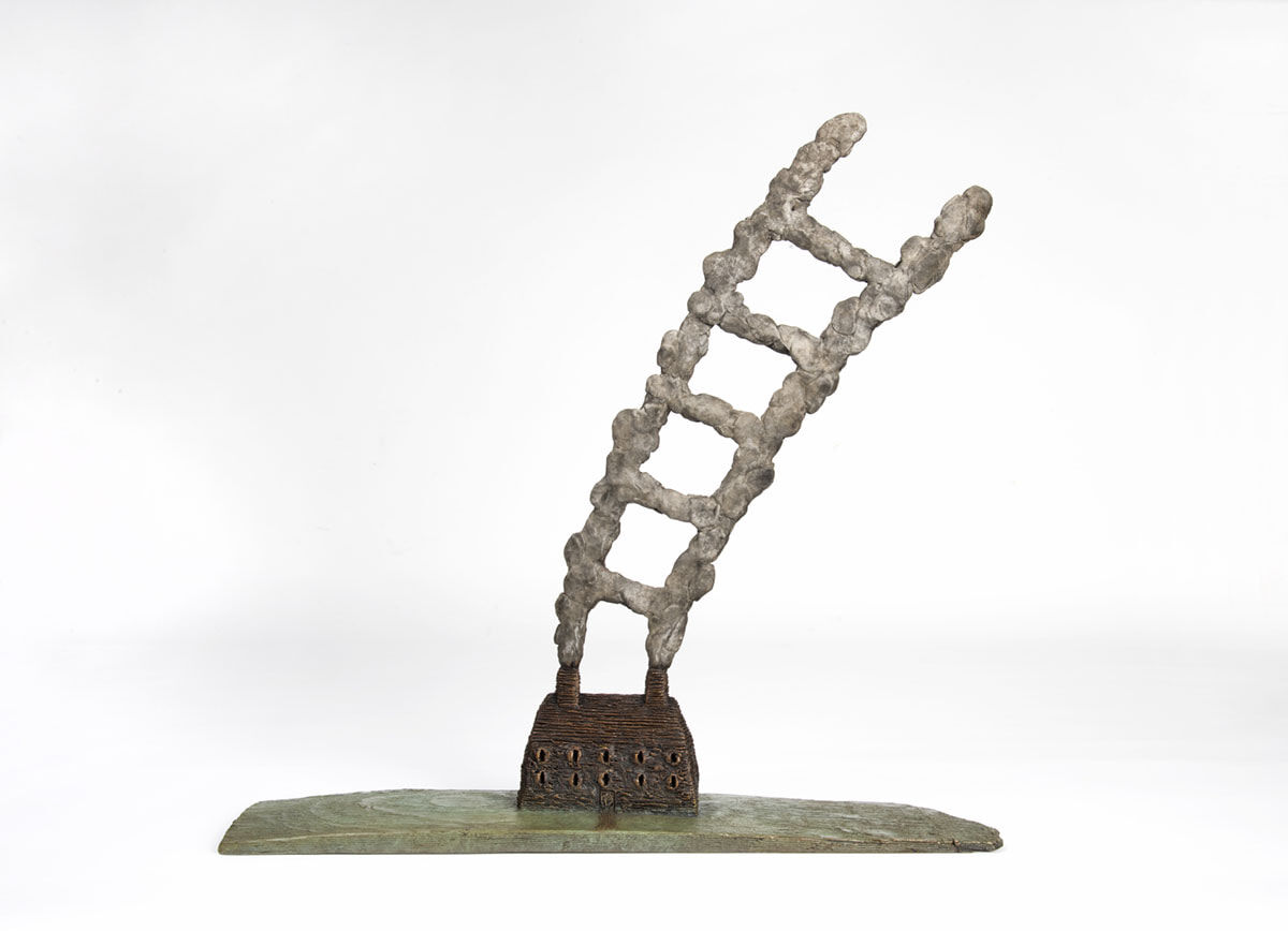 a bronze sculpture by Dean Bowen – 'Ladder to the Stars' made in 2020 (Bronze Unique Cast 46.5 X 47 X 10.5 cm) of a house with smoke coming out of the chimney forming the shape of a ladder.